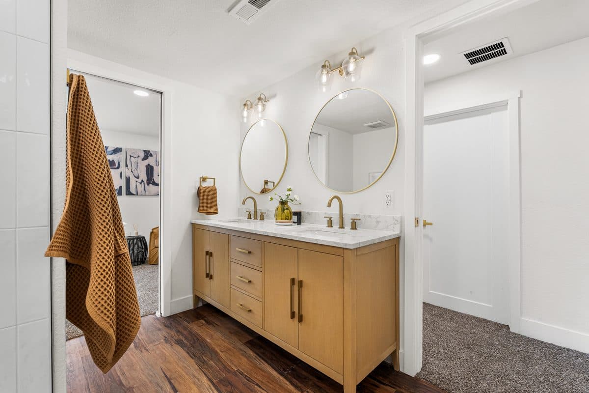 Primary bathroom with double vanity and gold hardware — Denver bathroom remodel