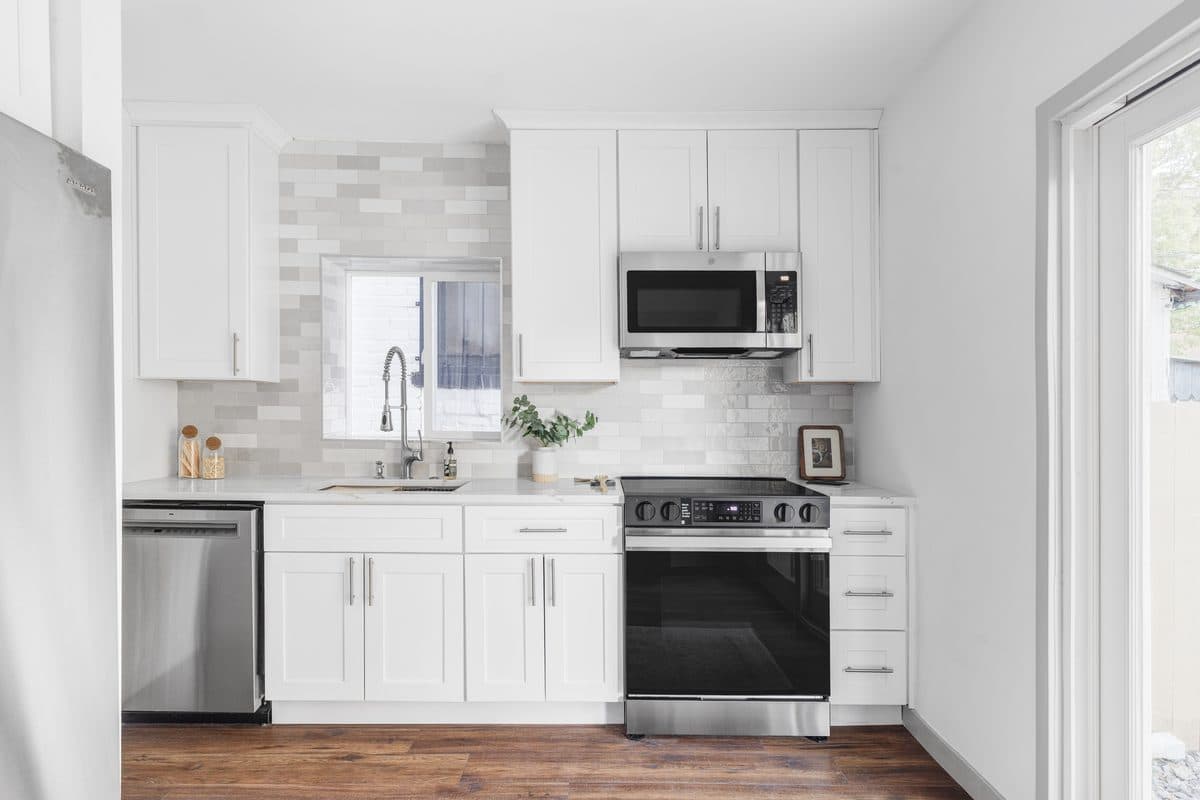 Renovated white kitchen with tile backsplash — Denver kitchen remodel